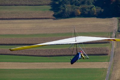 Hang glider over dirt road