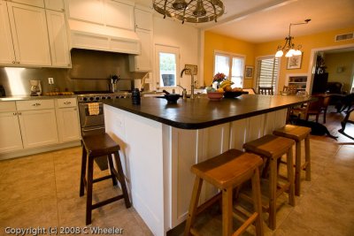 Finishes - soapstone island, stainless on counter and backsplash by stove, marble on 2 cabinets by DR and on the desk