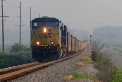 Humidity and haze hung in the air early as SB coal train passes the signal at Fort Branch
