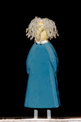 Blue carved Doll (standing on our casement frame looking inwards). Photographed from outside.