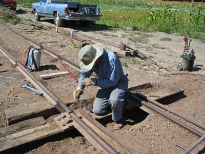 Bruce Sorrel drilling spike holes in an oak tie