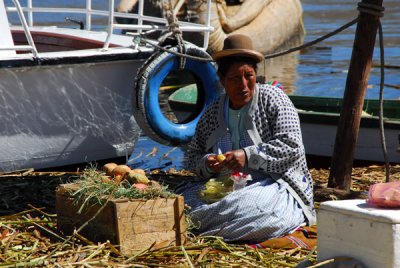 Uros woman peeling vegetables