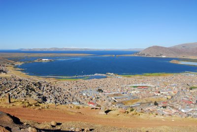 Puno and Lake Titicaca with snow covered Bolivian peaks in the distance
