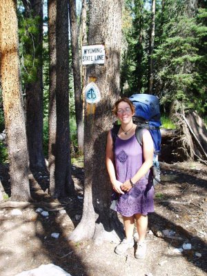 At the Wyoming Colorado sign in the woods
