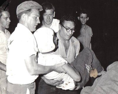 Tony Formosa Sr.  carrying a severly injured, Doc Norris.