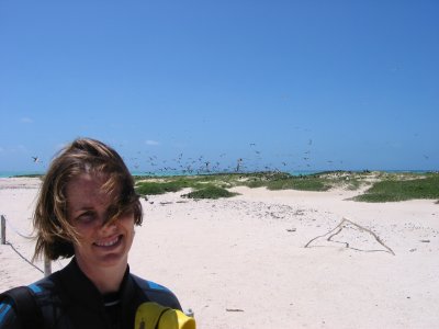 Chelle standing with the numerous birds in the background.