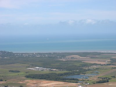 A view of Cairns and the coastline with a commercial plane on approach to Cairns airport (CNS)