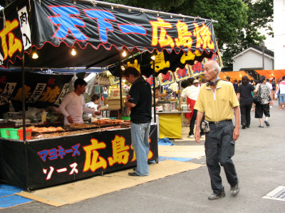 Hiroshima-yaki stand and passing local