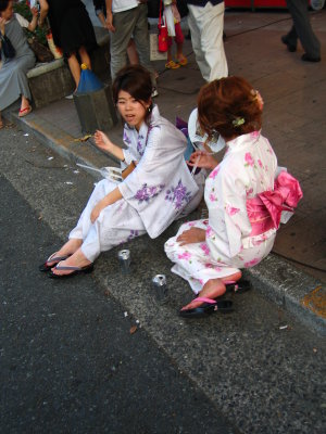 Yukata-clad spectators having beers