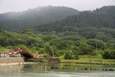 The sacred bridge and lush lakeside mountains