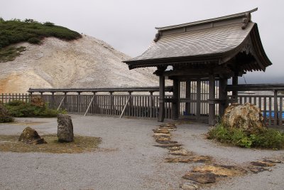 Gate and bare earth outside Osorezan-Bodaiji