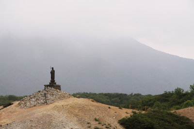 Lone hilltop jizō and cairn