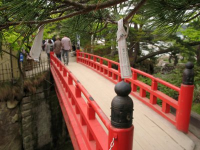 Omikuji hanging near a Godai-dō island bridge
