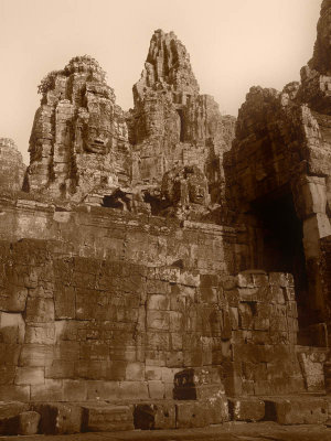 THE BAYON: SINISTER SMILE
12th - 13th century

In 1177, a surprise attack by the Chams resulted in the sacking of Angkor. The throne was regained in 1181 by King Jayavarman VII, a socially minded king and a prolific builder. He converted his people to Buddhism and centred his kingdom on the Bayon, in the middle of Angkor Thom. He built the temples of Prah Kahn, dedicated to his father, and Ta Prohm, dedicated to his mother, as well as numerous other temples, hospitals, roads and bridges. Following a period of decadence, Angkor exhausted itself and fell into decline. 