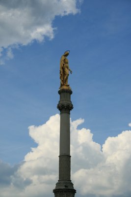 statue atop a column facing the cathedral