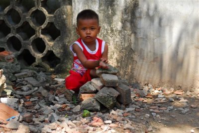 Boy playing with rocks