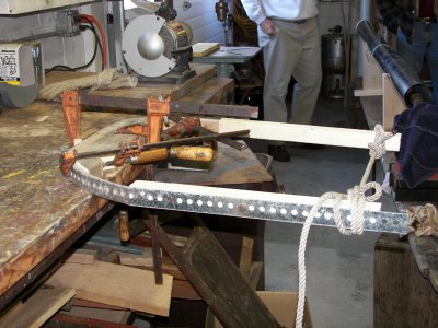 Once in place, the piece is clamped and the ends tied off with rope.