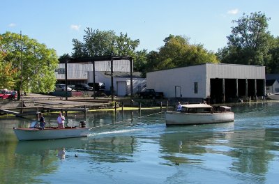 The Huckster passes by the old Richardson Boat Company, where she was built in 1935.