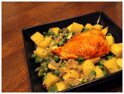 Pan seared chicken with potatoes and peas in chicken broth
