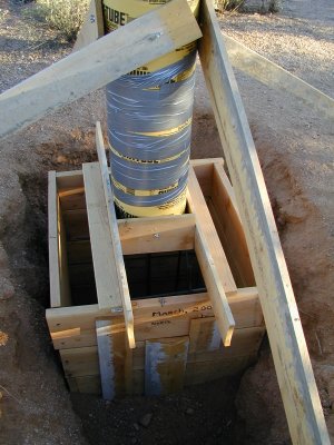 The base is 32 in. by 32 in. by 42 in. deep. The column is 48 in. tall and 12 in. in diameter. The hole was backfilled prior to pouring.
