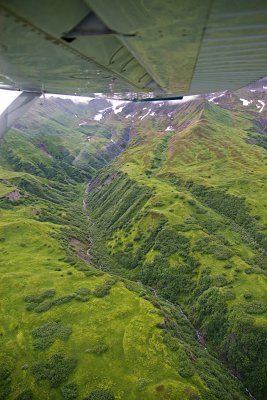 View out the plane of a mountain side