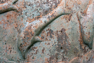 Running woman sculpture, dolphin detail on base