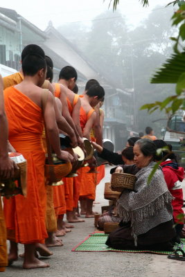 Early in the morning, the monks walk barefoot to get their food from the citizen - Luang Prabang - Laos