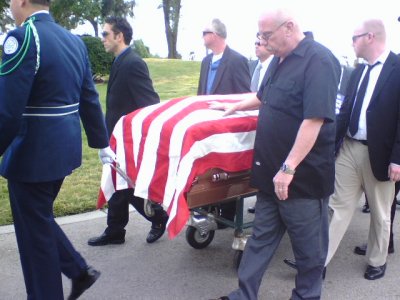 Leading Marvin from the Hearse to where the service will be.