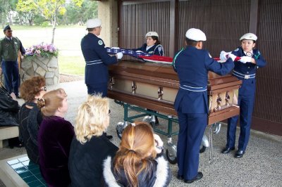 The folding of the American Flag above Marvin's coffin.