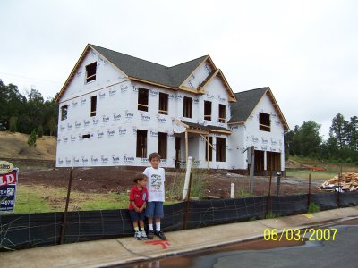 Evan and Ben posing outside the framed house
