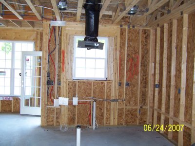 In kitchen, looking towards the back wall where the sink will be.  Cooktop will be on wall to the right.