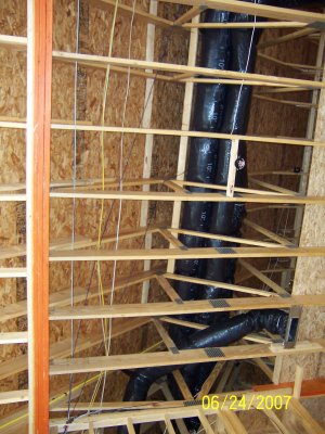 Wiring running in the ceiling over the family room.