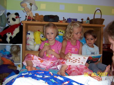 Our friends, Julie and Brett Kniss came to visit at the end of June as they were on there way from their home in Tennessee to spend a week at the North Carolina Coast.  Here is a picture of their two daughters, Sammie and Gracie, reading a book with Evan before bed.  Also, here is a link to a video of Sammie reading the book to them:http://www.youtube.com/watch?v=BWyhpeWxbJU