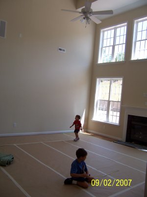 Ben and Evan playing in the family room.  Hardwood floors are in, just covered up with paper to protect them.