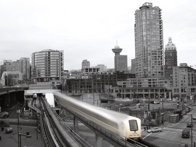 The Skytrain moves against Vancouver's skyline