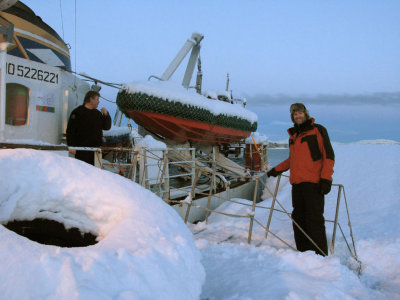 Jim boarding the snow-covered boat