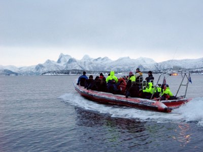 The snorklers in front sit on the pontoon sides