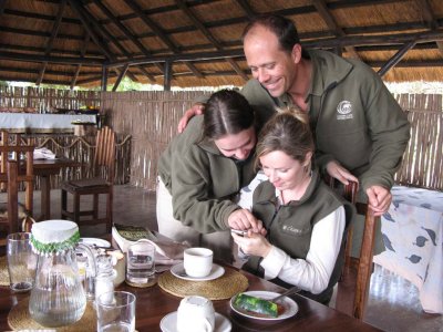Safari guides (Laura, Lynsey, and Grant Cumings) enjoy Jim's iPhone!