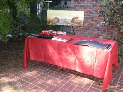 Table at entrance to wedding, with guest book and gifts (and a painting Stephanie painted of the young couple)