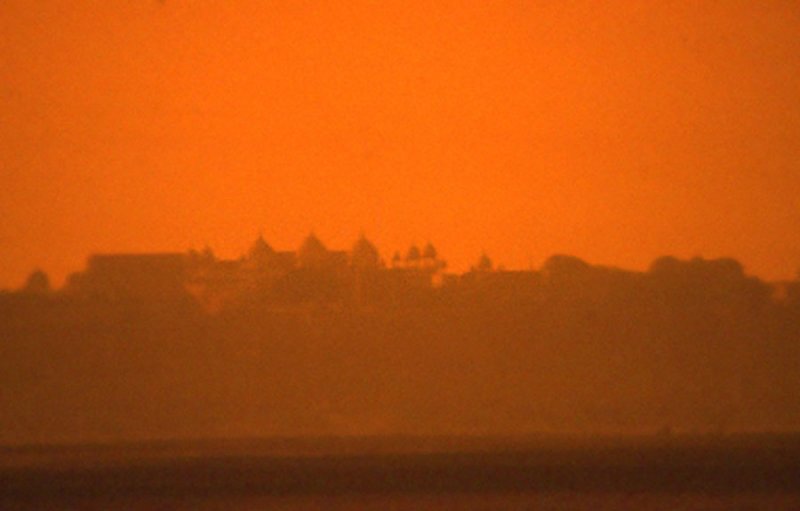Agra Fort in the sun setting distance.