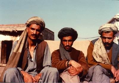 Three Mujahideen sitting in the sun