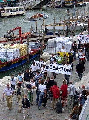 ubiquitous Venetian demonstrators pass workers unloading towels for delivery...