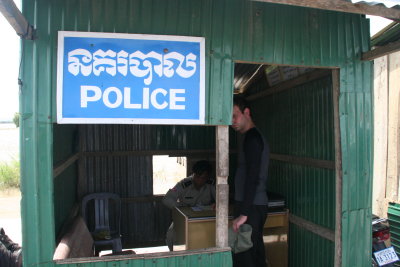 At the Cambodian border passports are checked in a metal hut