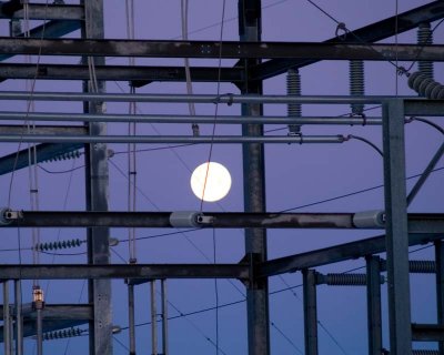 dawn moon behind power grid- tom
