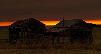 Old farm house with smoke haze sunrise by Dennis