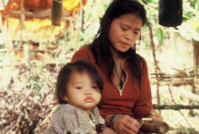 Mother and child somewhere in Kuba'an. Note the bamboo instrument that she is playing.