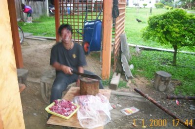 Cutting deer meat with parang