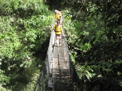 We crossed this hanging bridge and heard a outboard motor coming up.