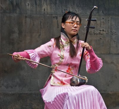 A girl plays the Erhu - Chinese fiddle