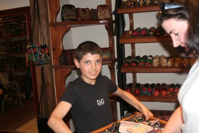 Boy helping Dad in a shoe store- a real charmer